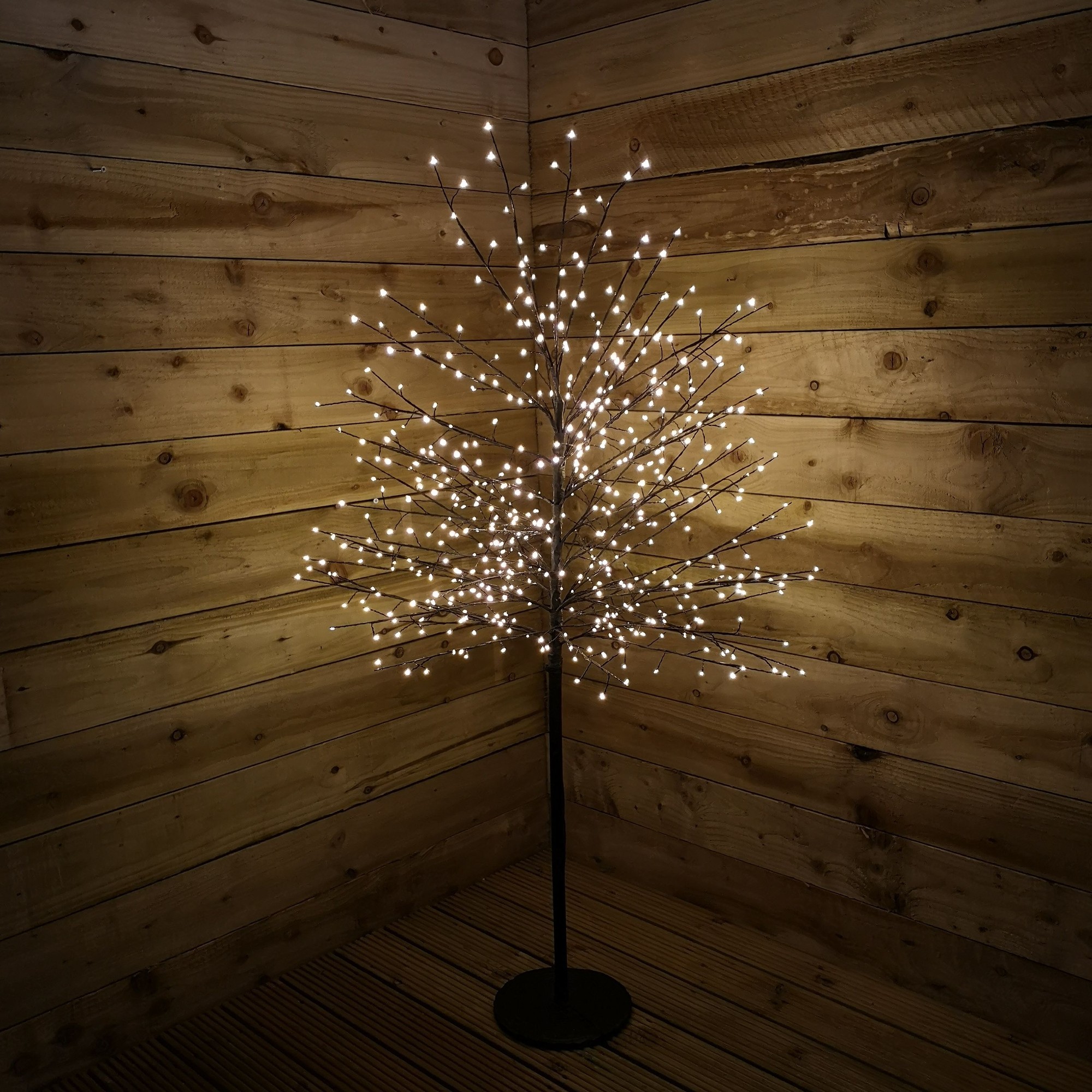 Outdoor black micro dot Christmas blossom tree, 1.5M tall, featuring 580 warm white LEDs, set against a rustic wooden backdrop.