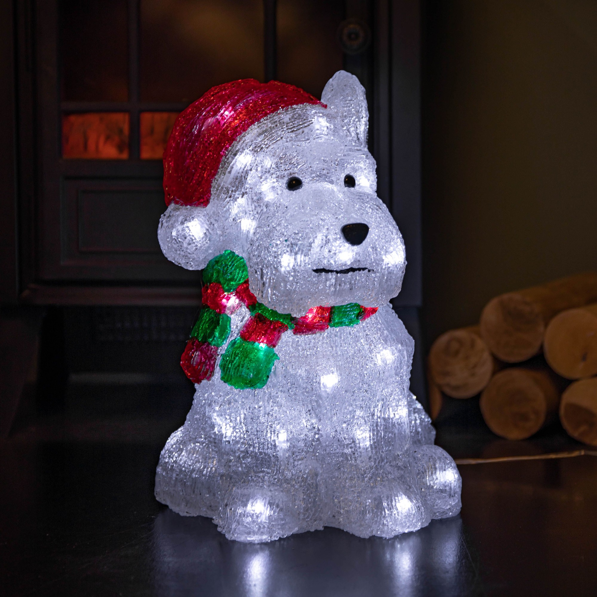 Light-up acrylic Westie dog decoration in white, wearing a red hat and green and red scarf, featuring 40 white LEDs for festive illumination, measuring 31 cm tall.