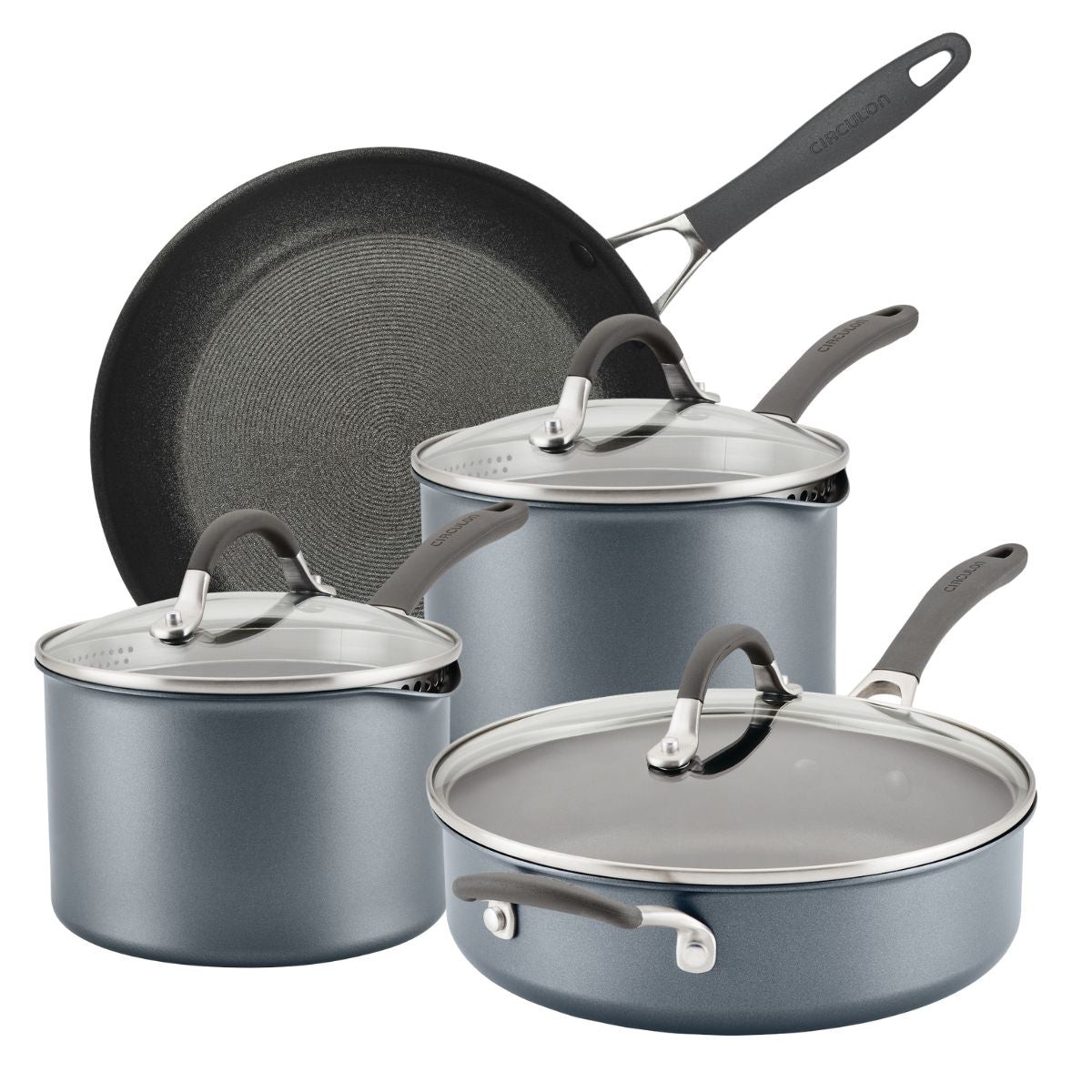 Four-piece cookware set featuring a black non-stick sauté pan and two gray saucepans with glass lids, all with ergonomic handles and a textured interior.