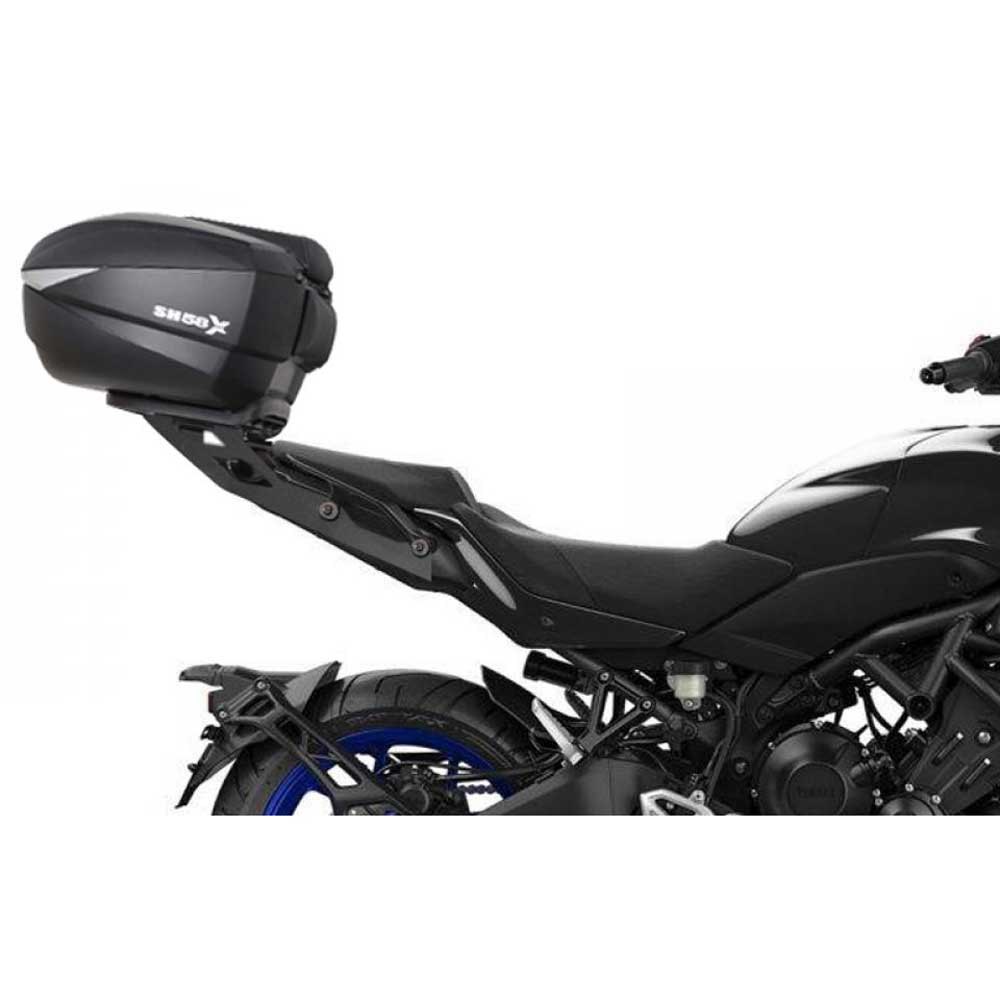Top Master Topcase Fitting by Shad, featuring a sleek black design, sturdy plastic material, and a streamlined shape, mounted on a motorcycle's rear for added storage.