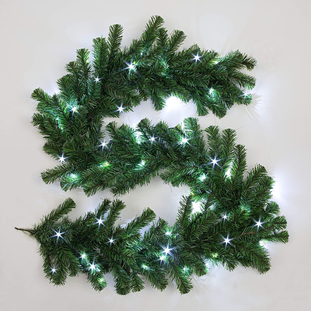 Green artificial garland with lush pine needle texture, featuring sparkling ice white LED lights interspersed throughout for a festive touch.