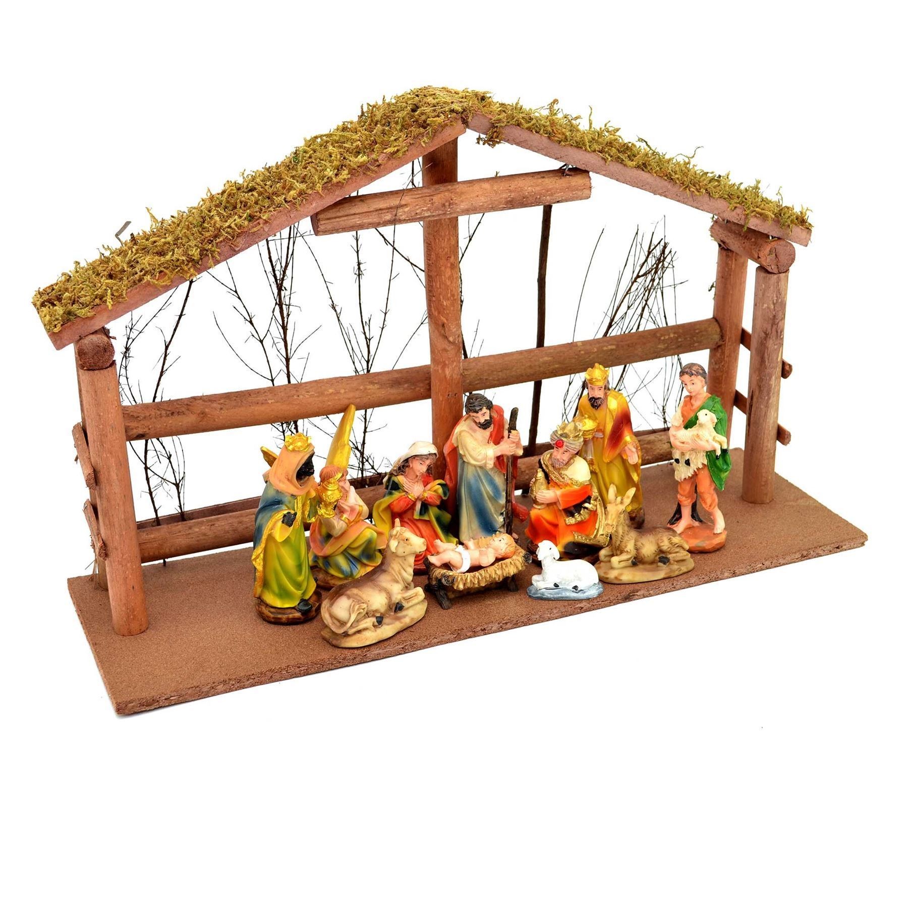 Large wooden nativity scene featuring colorful figurines of Mary, Joseph, baby Jesus, and animals, set in a rustic stable with a moss-covered roof and detailed base.
