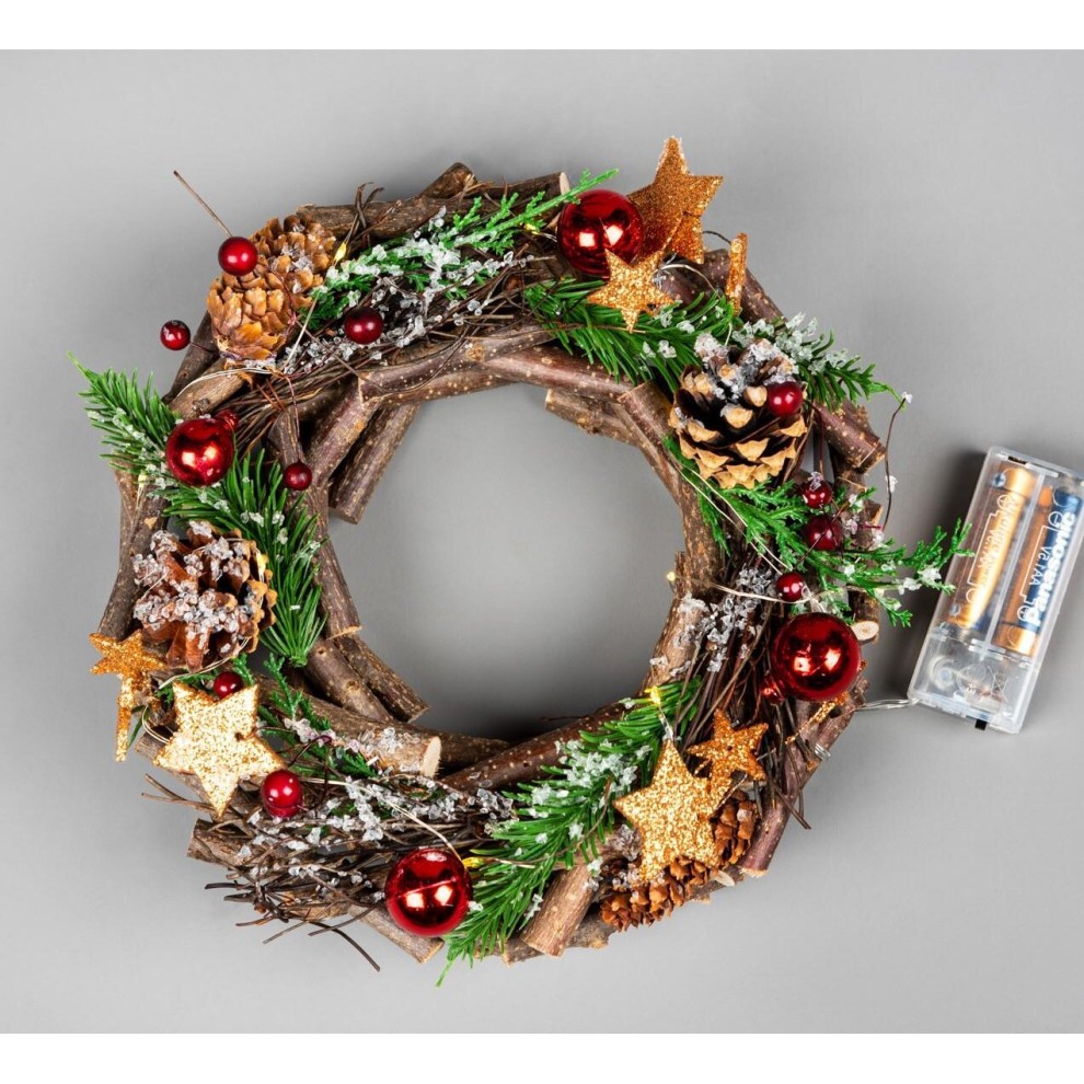 A 22cm wooden twig wreath adorned with bronze stars, red baubles, pinecones, and greenery, featuring LED lights and a battery pack on the side.