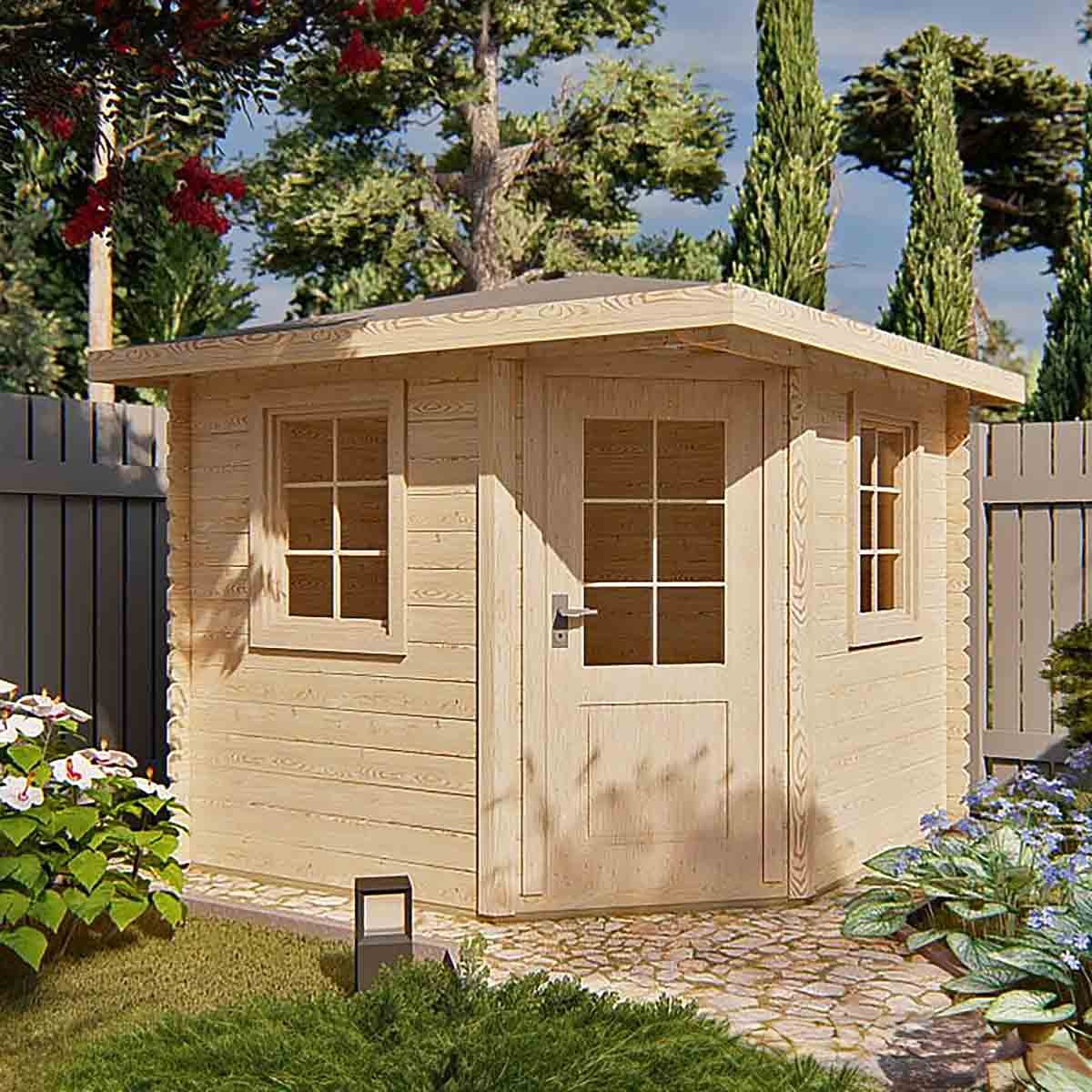 Brown log cabin with a flat roof, featuring large windows and a double door, surrounded by greenery and flowers in a garden setting.