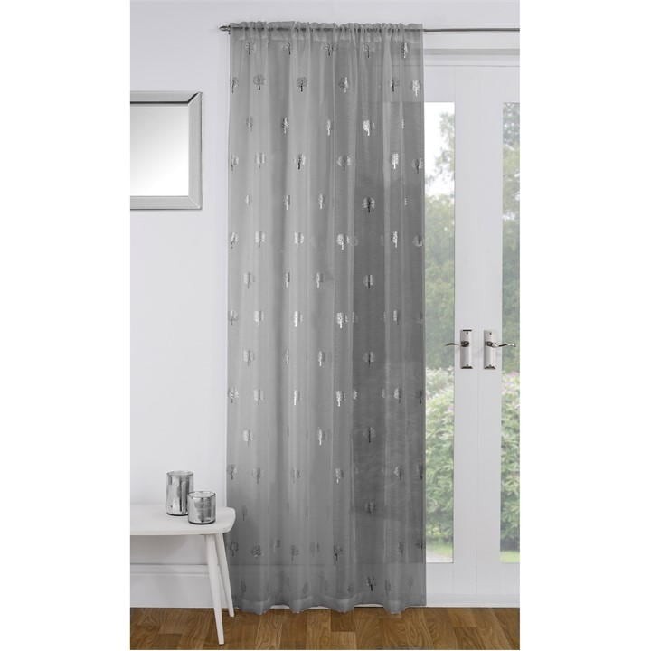 Grey voile panel featuring a metallic birch tree print, designed by Tyrone Textiles, with a sheer, lightweight fabric that allows light to filter through.