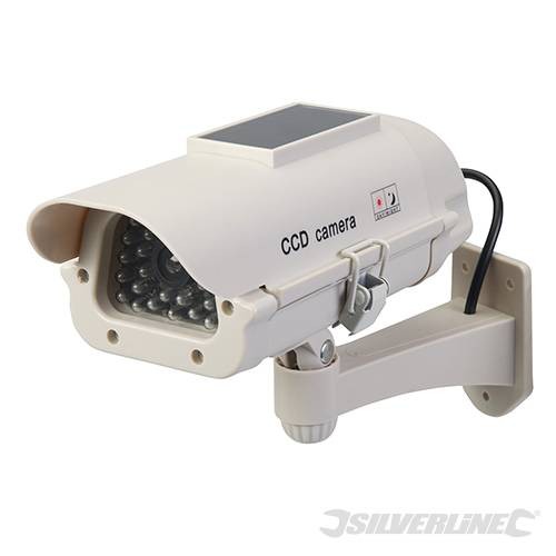 Silverline solar-powered dummy CCTV camera in white plastic with a black LED light, featuring a solar panel on top and a mounted bracket for easy installation.