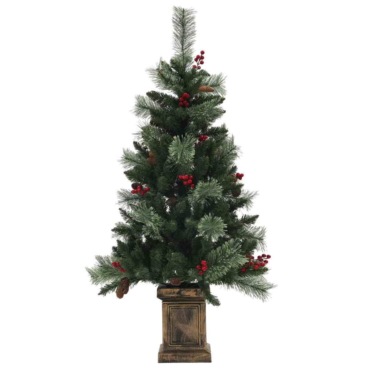 Green prelit Christmas tree standing 4ft tall, adorned with 100 warm white LED lights, red berries, and pinecones, set in a decorative wooden base.