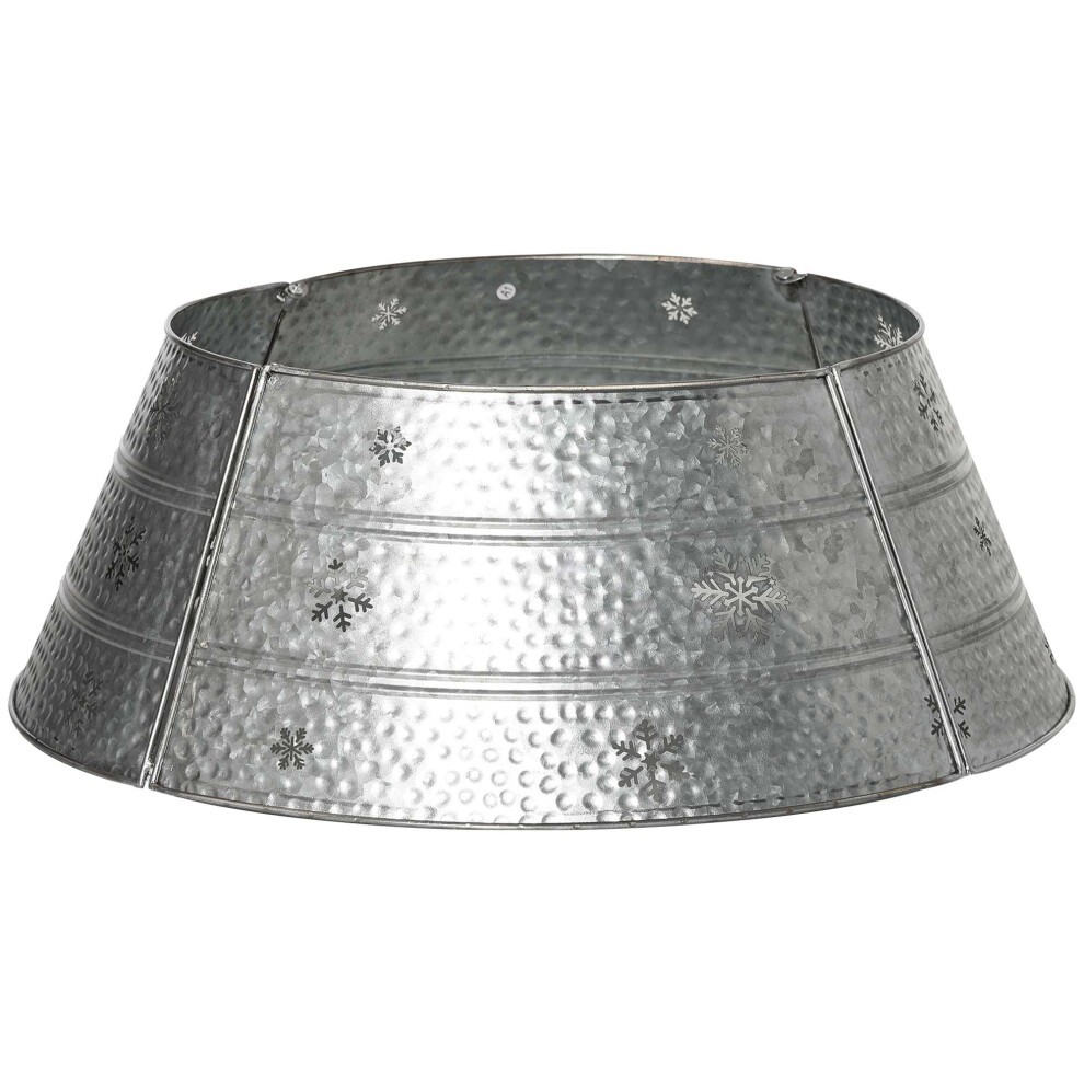 Silver metal Christmas tree collar featuring hollow snowflake patterns, with a textured, hammered finish and a 66cm diameter design.