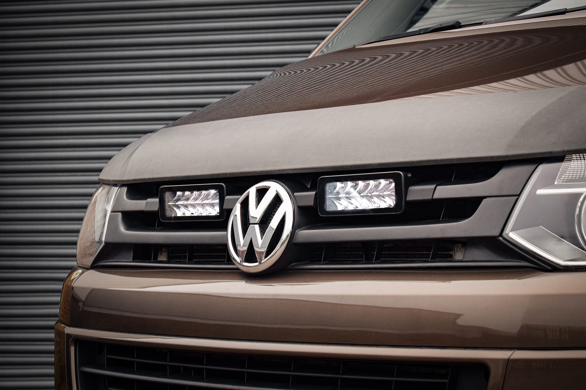 Stealth LED integration kit for VW Transporter T5.1, featuring twin 7" luminous LED lights, sleek black housing, and high-output 10,080 lumens, mounted on a brown vehicle grille.