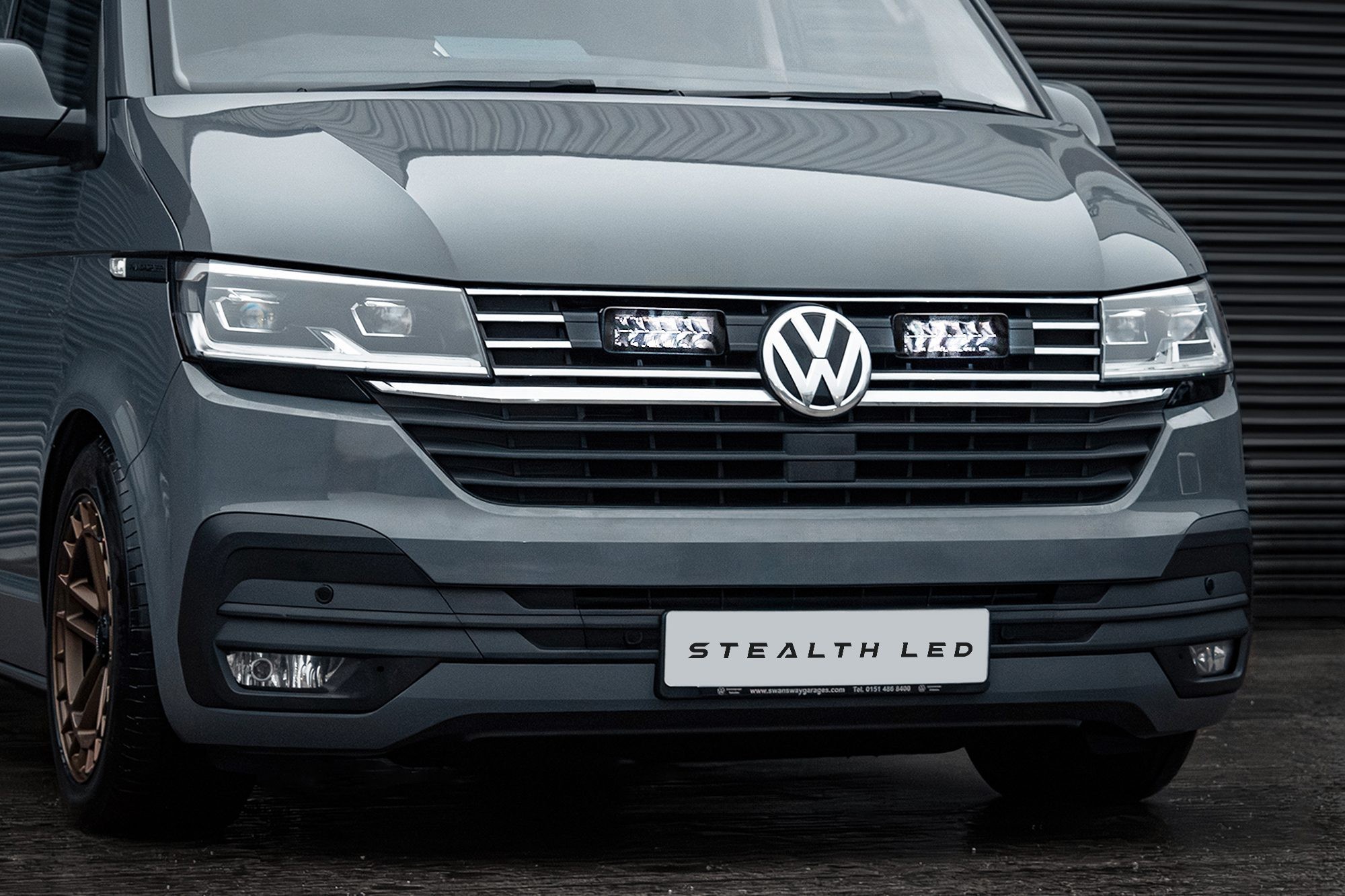 Stealth LED integration kit for VW Transporter T6.1, featuring twin 7" luminous LED lights, silver accents, and a sleek gray vehicle front with a prominent VW logo.
