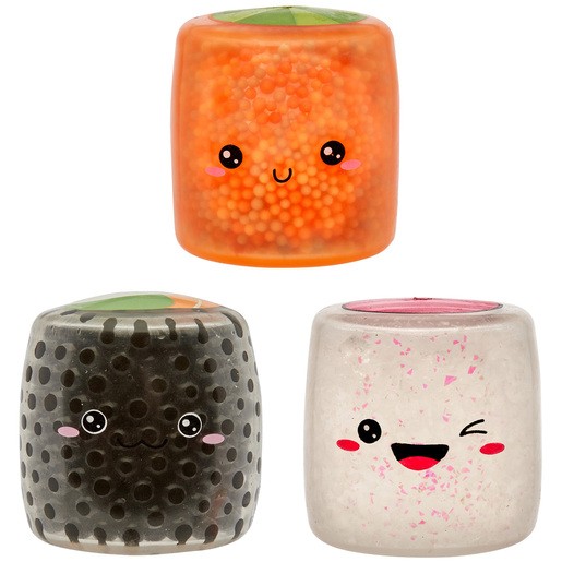Three squishy fidget toys resembling sushi: an orange salmon, a black seaweed roll, and a white rice roll, all with cute facial expressions and textured surfaces.
