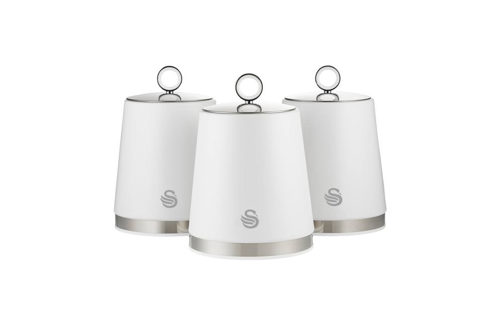 Three white kitchen canisters with a sleek design, featuring a silver base and a circular lid handle, adorned with the Swan logo on the front.