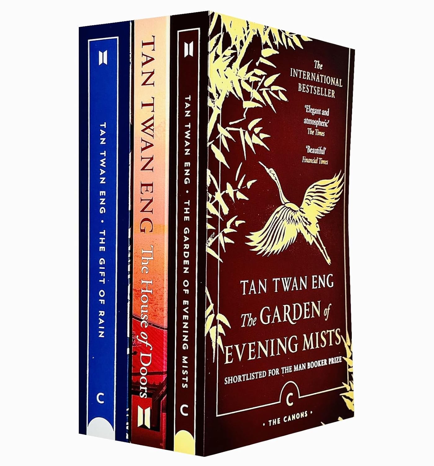 Three paperback books by Tan Twan Eng, featuring colorful spines in blue, red, and cream, with the title "The Garden of Evening Mists" prominently displayed on the front.