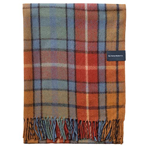 Recycled wool blanket in Buchanan Antique Tartan pattern featuring warm hues of orange, blue, and red, with fringed edges and a label from The Tartan Blanket Co.