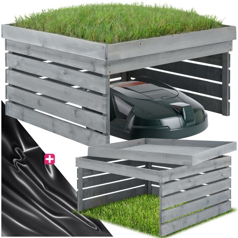 Grey wooden garage for a robot lawn mower, featuring slatted sides and a grass-covered top, measuring 84 x 78 x 46 cm, with a sleek black mower partially visible inside.