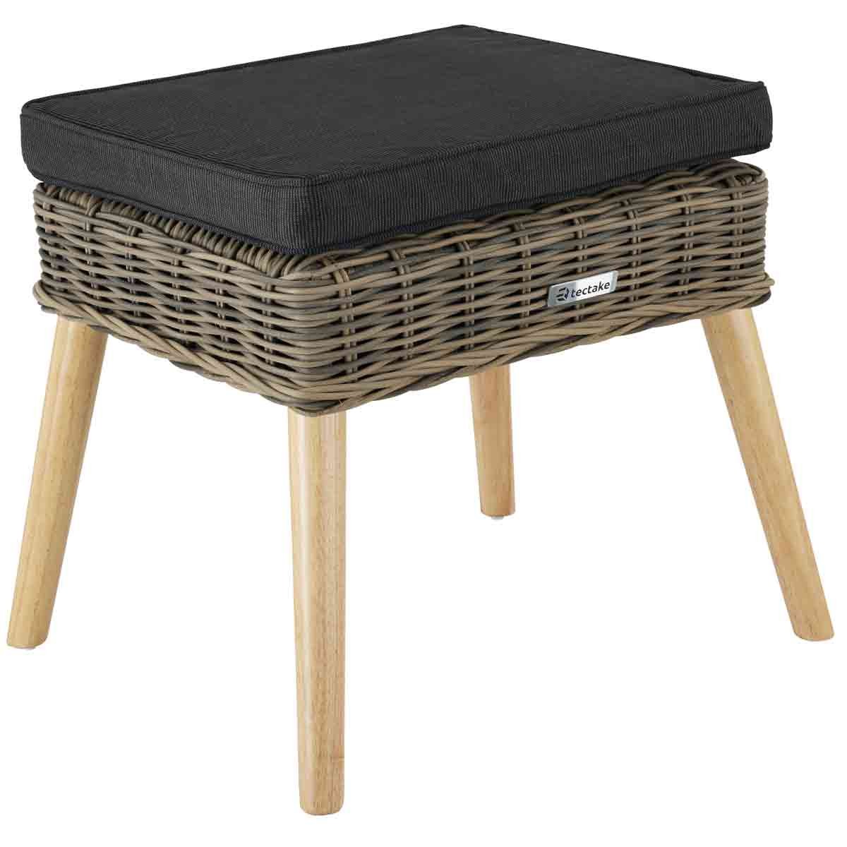 Brown wicker footstool with a comfortable black cushion on top, featuring wooden legs and a modern design, perfect for indoor or outdoor use.