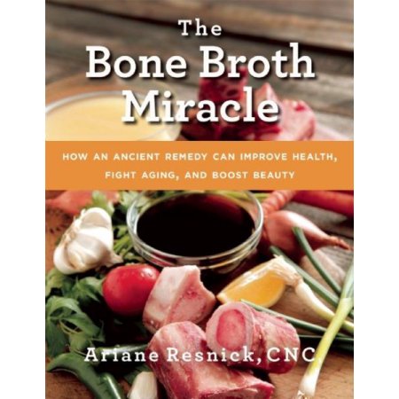 Cover of "The Bone Broth Miracle" eBook features a wooden table with ingredients like raw meat, vegetables, and a bowl of broth, with a vibrant orange banner and white text.