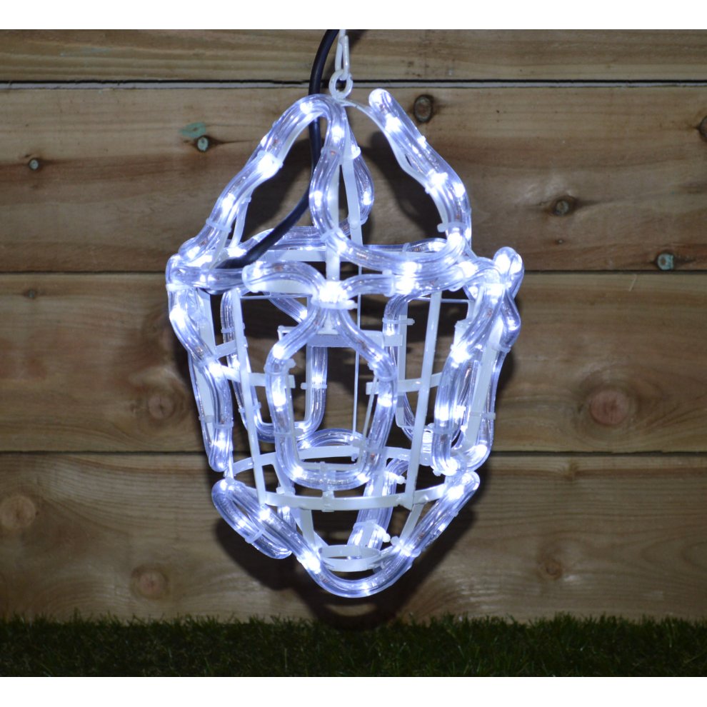 White LED rope light shaped like a lantern silhouette, featuring a wireframe design, hanging against a wooden backdrop.