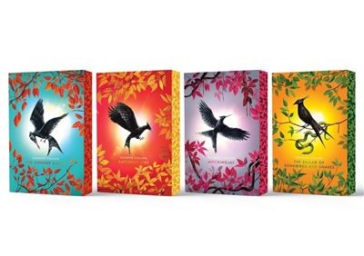 Four hardcover books in a deluxe collection, featuring vibrant covers with stylized birds and colorful autumn leaves, showcasing distinct hues of blue, red, orange, and yellow.