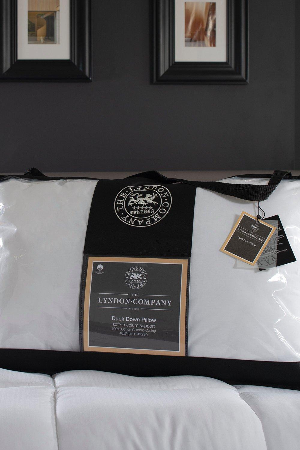 White duck down pillow with a soft medium support label, packaged in a clear plastic cover with black accents and The Lyndon Company logo.
