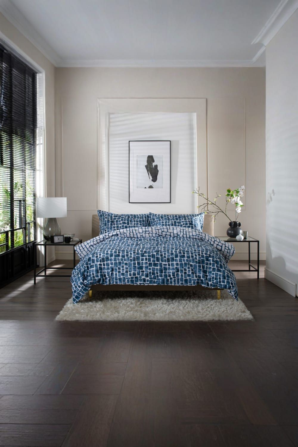 Navy tulle extrasoft 100% cotton duvet cover set displayed on a super king bed, featuring a textured geometric pattern, complemented by a cozy rug and modern bedside decor.