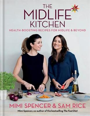 Hardcover cookbook titled "The Midlife Kitchen" by Mimi Spencer, featuring a colorful cover with two women preparing food, surrounded by fresh ingredients and a vibrant kitchen setting.