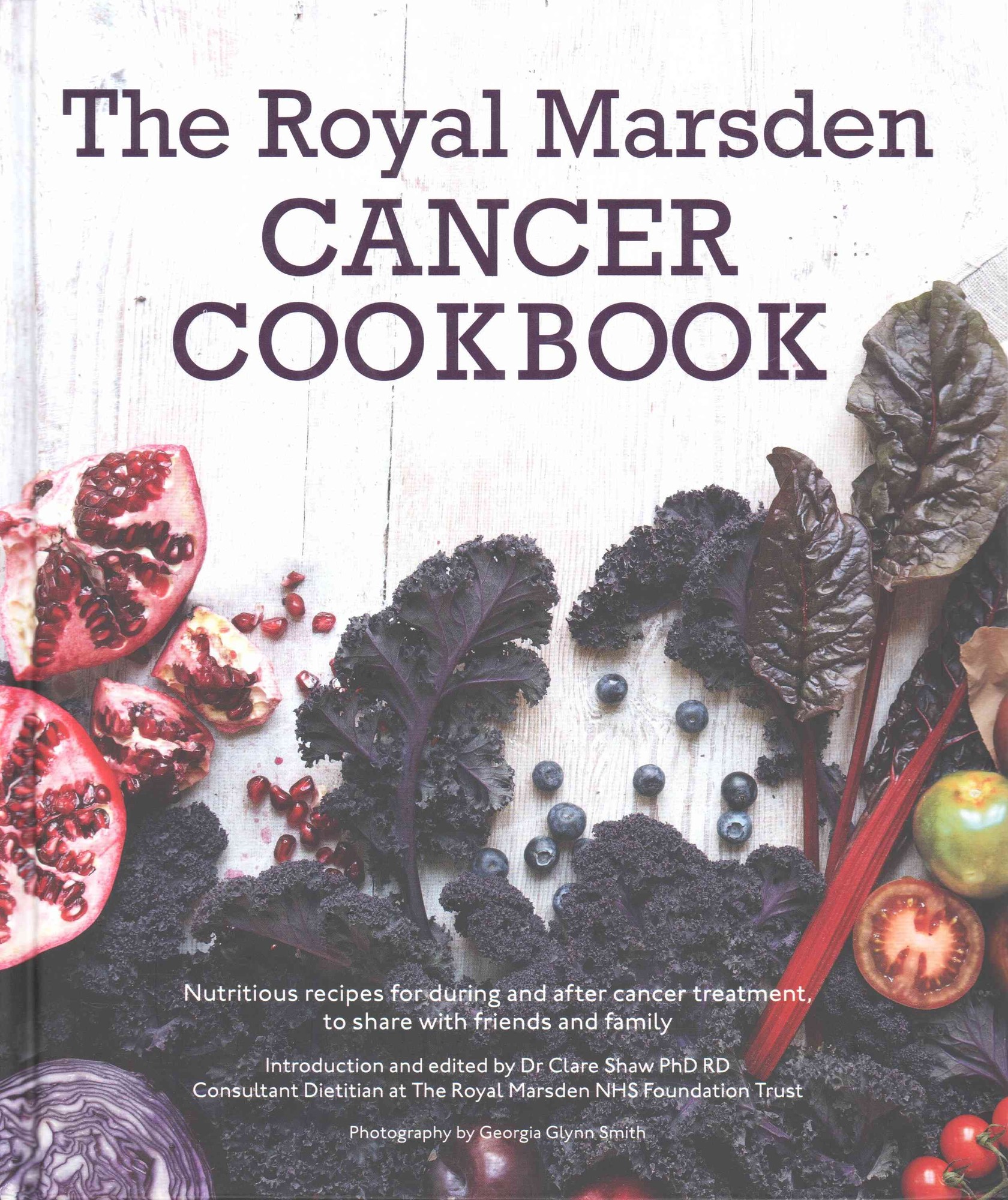 Cover of "The Royal Marsden Cancer Cookbook" featuring vibrant vegetables like kale and tomatoes, with bold purple text and a clean, modern design.