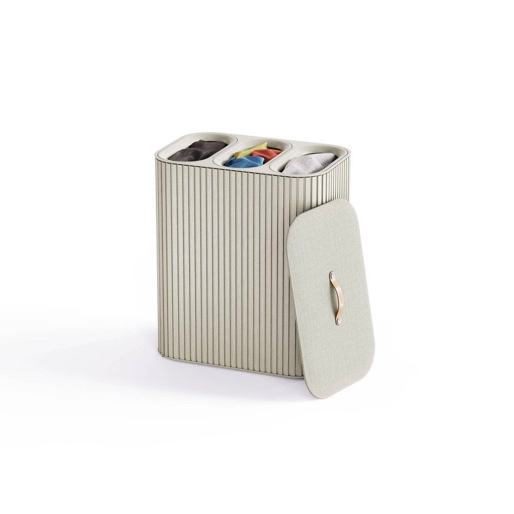Bamboo laundry basket with a sleek, vertical stripe design, featuring three compartments in soft colors and a lid with a gold handle for easy access.
