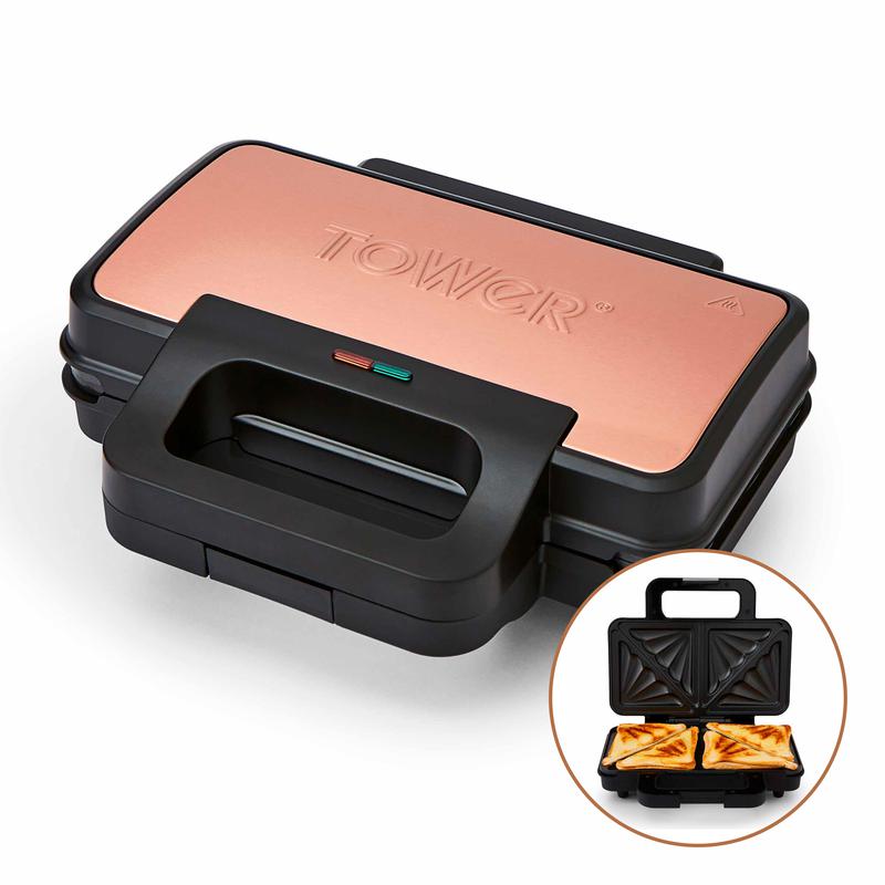 Black sandwich maker with a copper finish on the lid, featuring a prominent "TOWER" logo, a handle for easy opening, and a circular inset showing two toasted sandwiches inside.