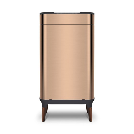Stylish copper-colored 65-litre sensor bin by Tower, featuring a sleek metal finish, a black lid, and wooden legs for an elegant touch.