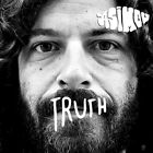 Close-up of a man with long, wavy hair and a beard, featuring intense eyes, with the word "TRUTH" written in bold, white letters across his mouth.