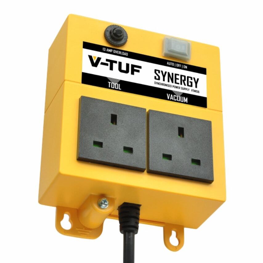 Yellow power tool and vacuum synchronizer with two black sockets, labeled "V-TUF SYNERGY," featuring an overload indicator and a switch for auto/off/on settings.