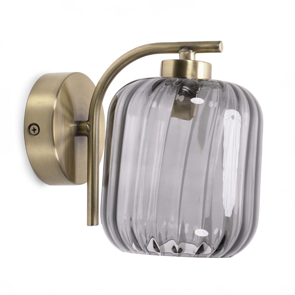 Gold metal wall light featuring a ribbed glass shade in a soft gray hue, designed to hold LED bulbs, with a sleek, modern aesthetic.