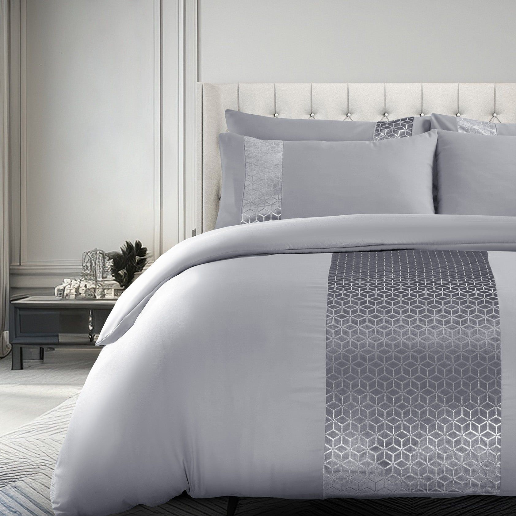 Stylish gray foil printed luxury bedding set featuring a duvet cover with a geometric design and matching pillowcases, set against a tufted headboard and elegant bedroom decor.