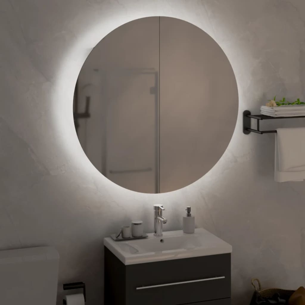 Compact black bathroom cabinet made of engineered wood, featuring a sleek design with a glass top, copper accents, and a round illuminated mirror above it.