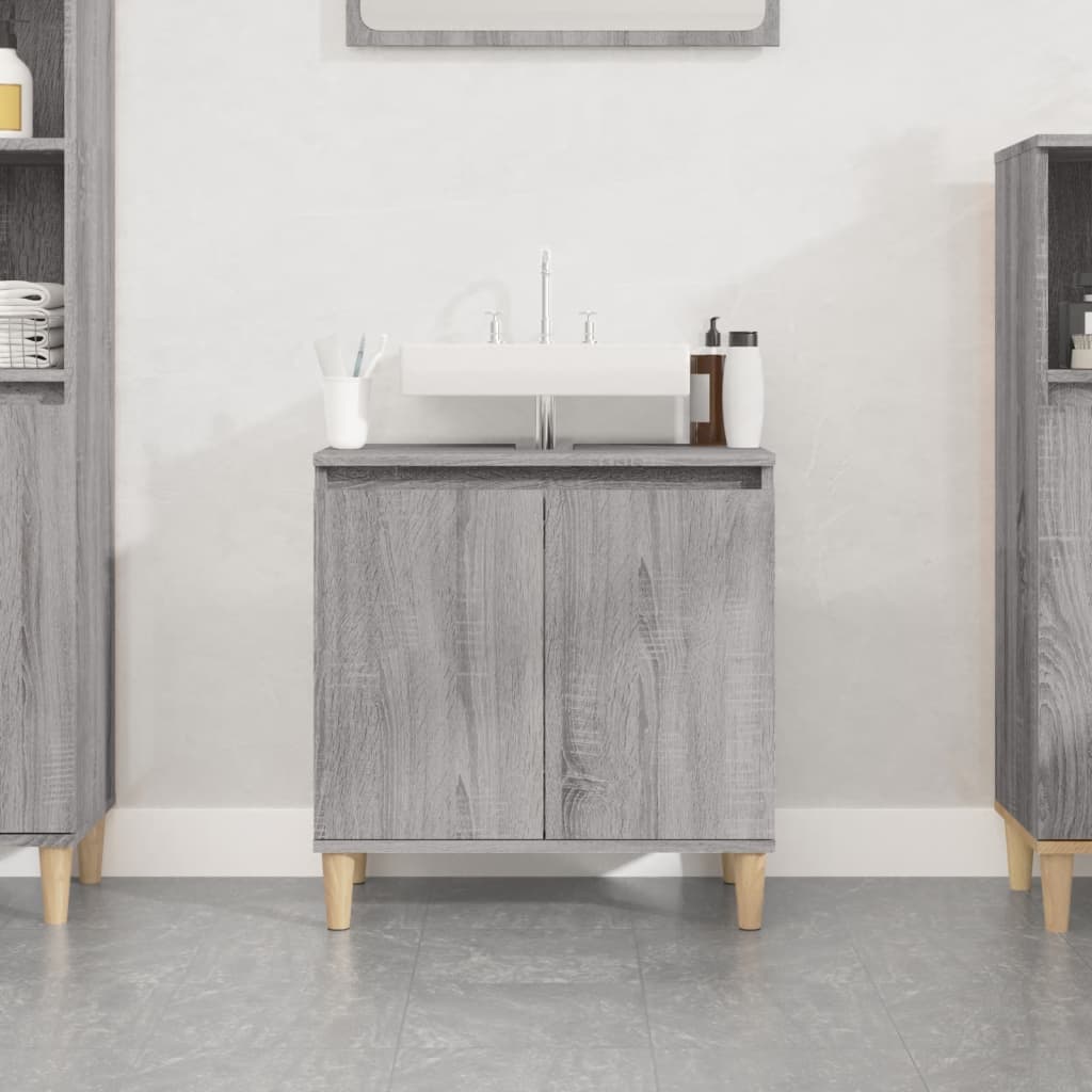 Grey Sonoma sink cabinet made of engineered wood, featuring two doors, a smooth top for a sink, and wooden legs, ideal for modern bathroom decor.