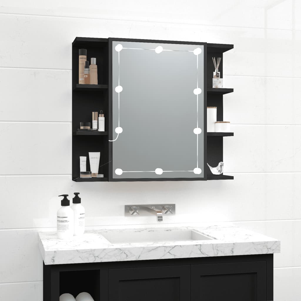 Black mirror cabinet with LED lights, featuring a central mirror and side shelves for storage, set against a white tiled wall and marble countertop.
