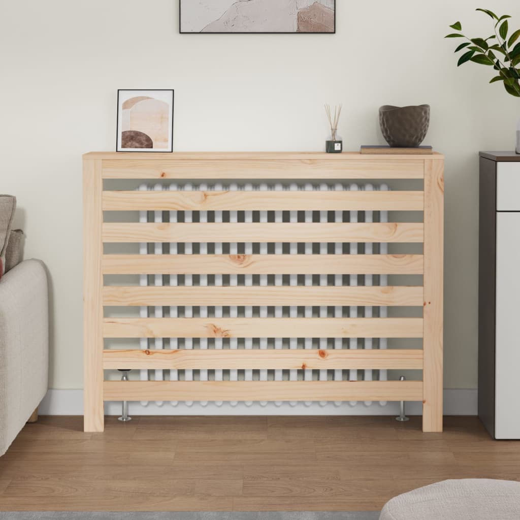 Solid wood pine radiator cover in natural finish, measuring 108.5x19x84 cm, featuring a slatted design that allows heat circulation, placed against a light-colored wall.