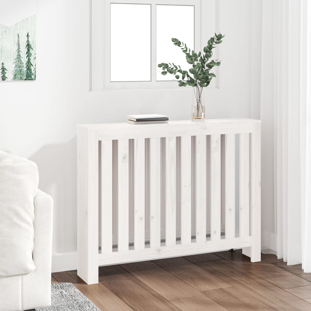 White solid wood pine radiator cover with slatted design, measuring 42.7x7.5x33.1 inches, placed next to a window and decorated with a vase and book.