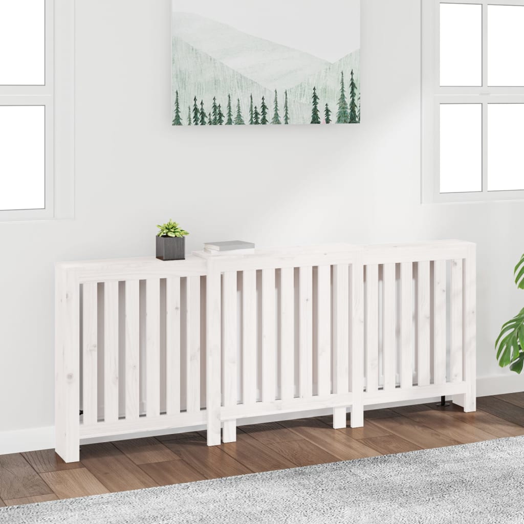 White solid wood pine radiator cover measuring 82.7x8.3x33.5 inches, featuring a slatted design, placed against a wall with greenery and a mountain-themed artwork above.