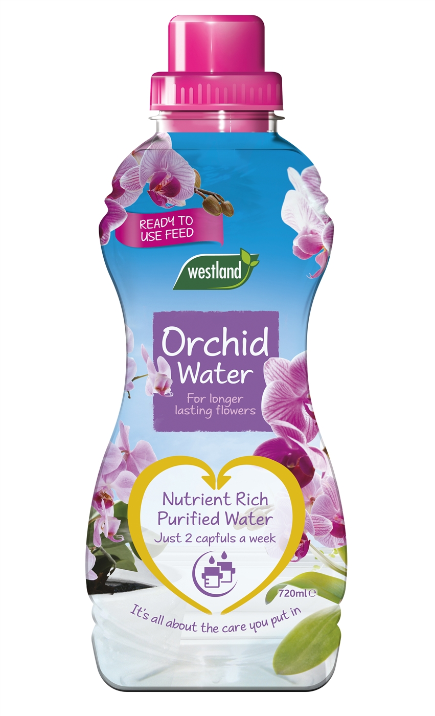 Clear plastic bottle of Westland Orchid Water, featuring a pink cap, vibrant blue label with purple orchids, and a yellow heart-shaped logo stating "Nutrient Rich Purified Water."