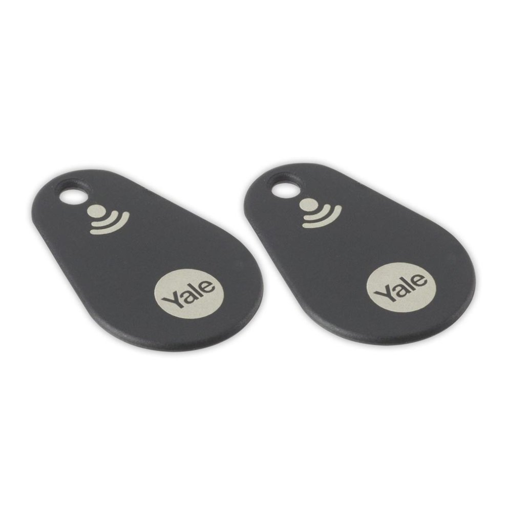 Two black Yale contactless tags with a smooth finish, featuring a silver logo and a wave symbol, designed for keyless entry systems.
