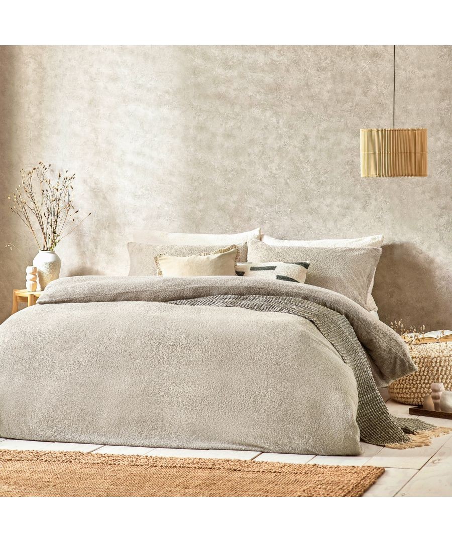 Beige boucle textured duvet cover set in double size, featuring soft, plush fabric, layered with decorative pillows and a cozy throw, styled in a serene bedroom setting.