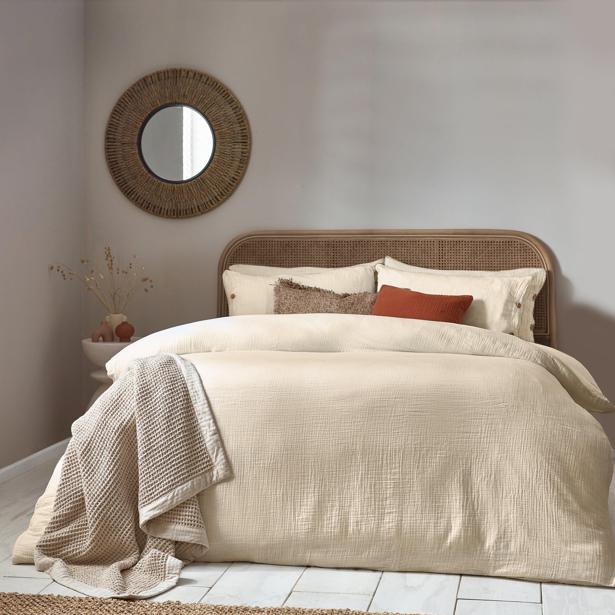 Natural muslin cotton duvet cover set in a super king size, featuring a soft beige color, textured fabric, and styled with decorative pillows and a woven throw on a bed.