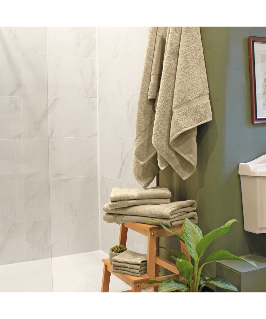 Beige cotton towel bale featuring ten pieces, including bath towels, hand towels, and washcloths, displayed on a wooden stool in a bathroom setting.