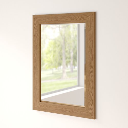 Natural oak effect framed wall mirror measuring 75.5x103.5cm, featuring a simple rectangular design with a light wood finish, reflecting a bright outdoor scene.