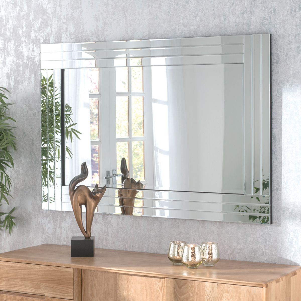 Triple surround wall mirror in black, measuring 120x80cm, featuring sleek mirrored panels and a modern design, displayed above a wooden console with decorative items.