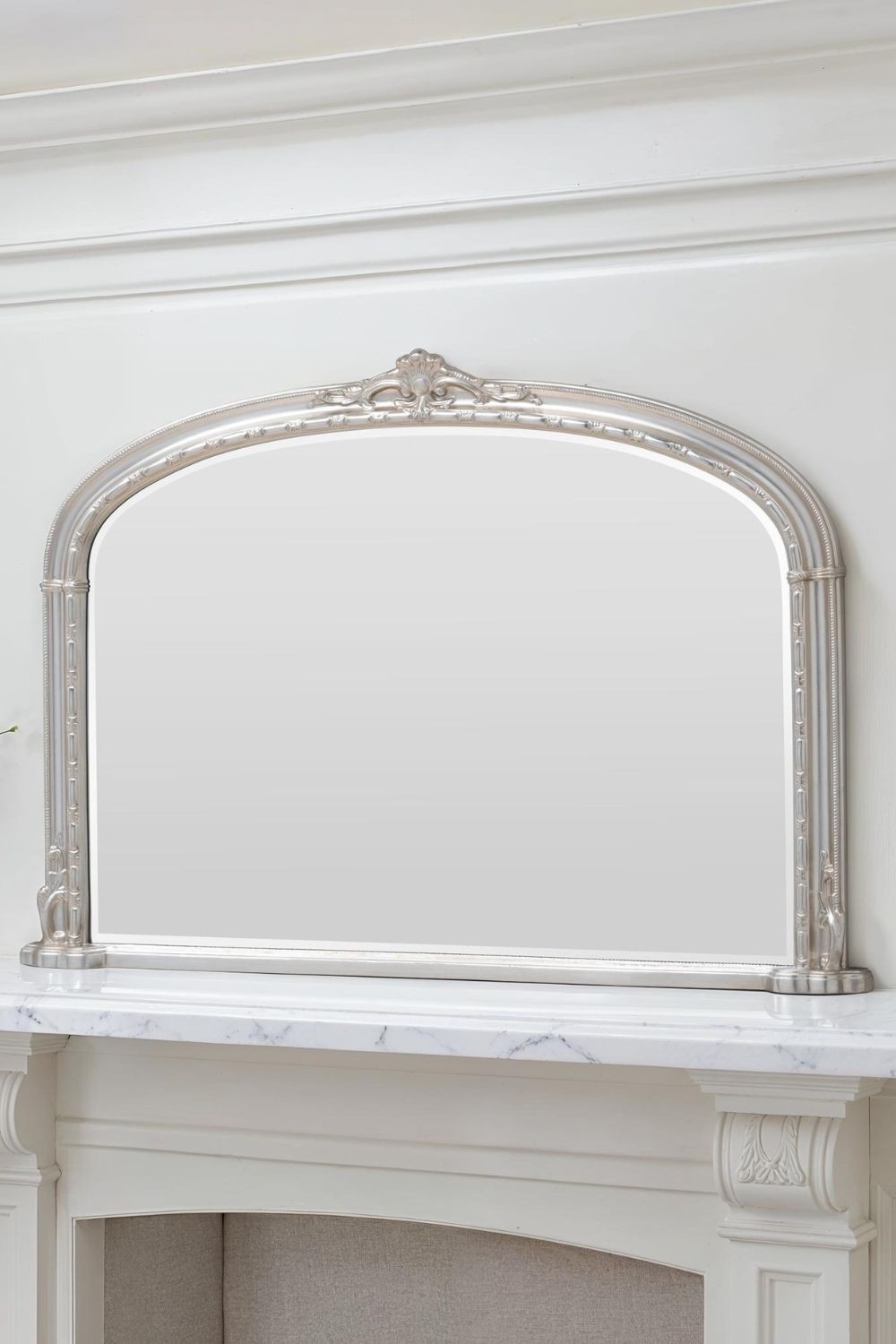 Arched Victorian mirror in silver, measuring 127cm wide and 89cm high, featuring ornate detailing and a sleek reflective surface, perfect for overmantle display.