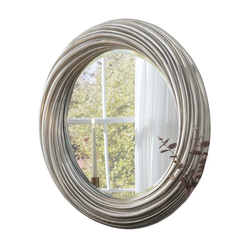 Large round mirror with a silvery champagne metallic finish, featuring a textured, ribbed frame and measuring 84cm in diameter, reflecting natural light.