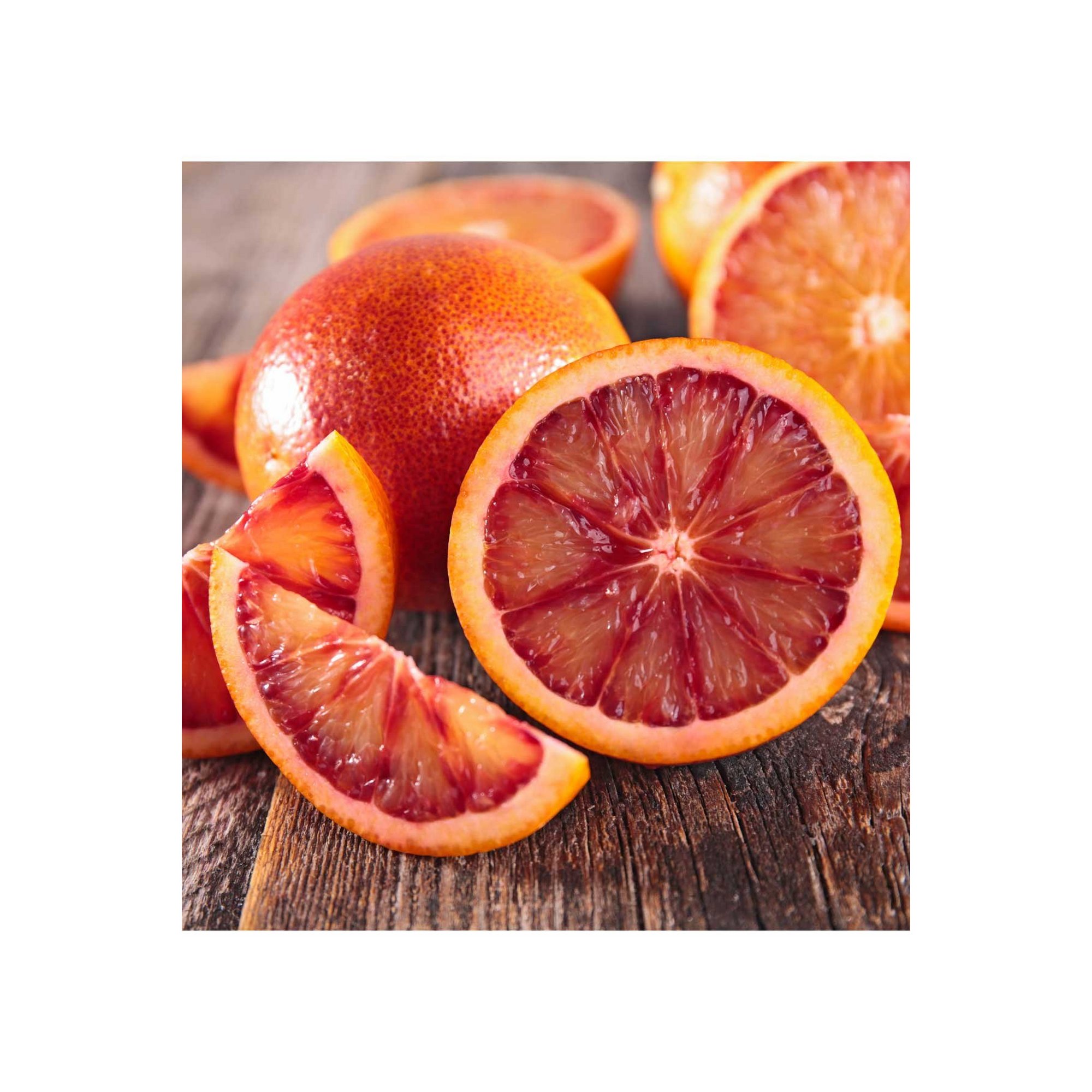 Bright red and orange blood oranges, sliced to reveal their vibrant inner color, sit on a rustic wooden surface, showcasing their juicy texture and fresh appeal.